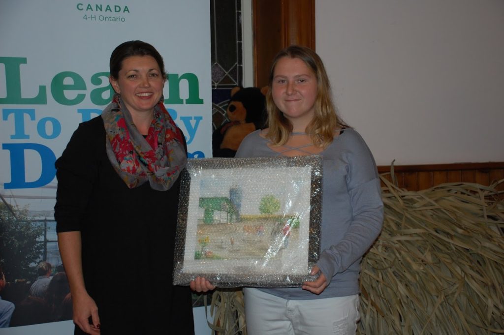 <p>Selena Prinzen presents the Gay Lea Award of Achievement to Michaela Zantingh during Saturday’s ceremony. (Submitted photo)</p>
