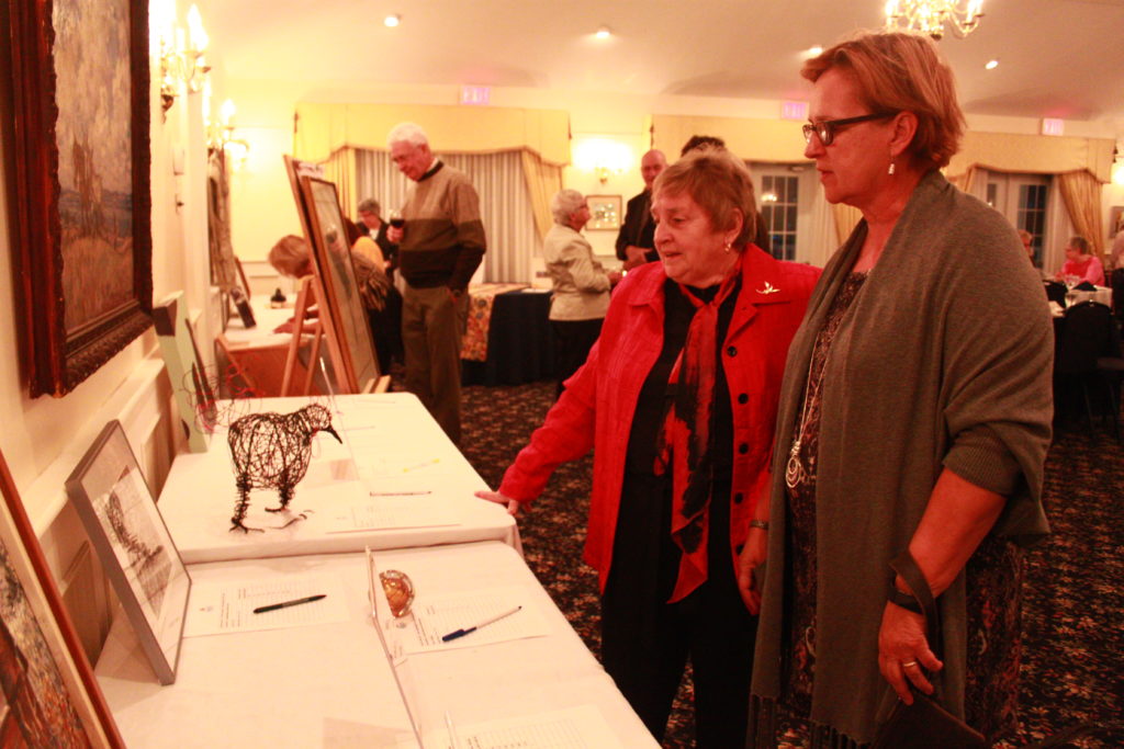 <p>Sandy de Sousa and Margaret Christie inspect some of the auction items up for grabs at Saturday’s PEPtBO fundraiser.</p>
