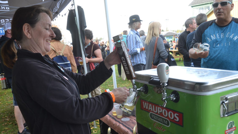 <p>Perfect Pour – Jenifer Dean, of the County Cider Company grabs a glass of her product to allow a potential customer to sample during Saturday’s Homegrown festival at the Picton fairgrounds. (Jason Parks/Gazette staff)</p>
