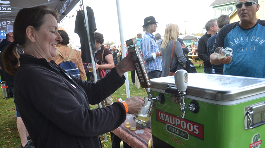 <p>Perfect Pour – Jenifer Dean, of the County Cider Company grabs a glass of her product to allow a potential customer to sample during Saturday’s Homegrown festival at the Picton fairgrounds. (Jason Parks/Gazette staff)</p>
