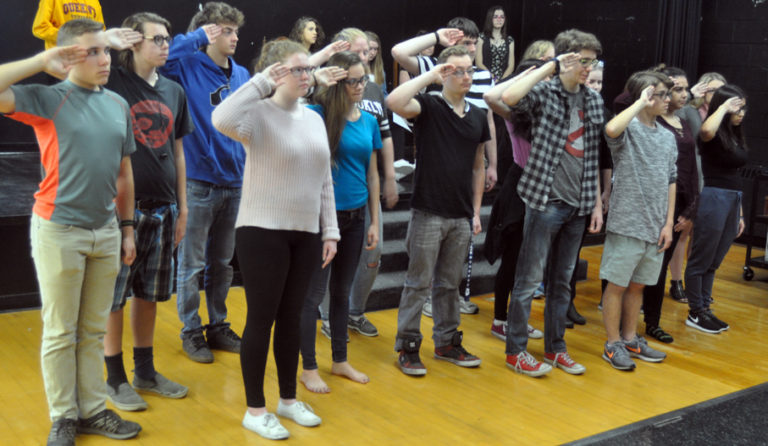 <p>A salute to local history – PECI drama students practice their salute during a scene in Vimy and the child soldier from Hillier where the township’s fallen veterans are remembered. The student are working on staging the play for community and in-school performances for Remembrance Day. (Adam Bramburger/Gazette staff)</p>

