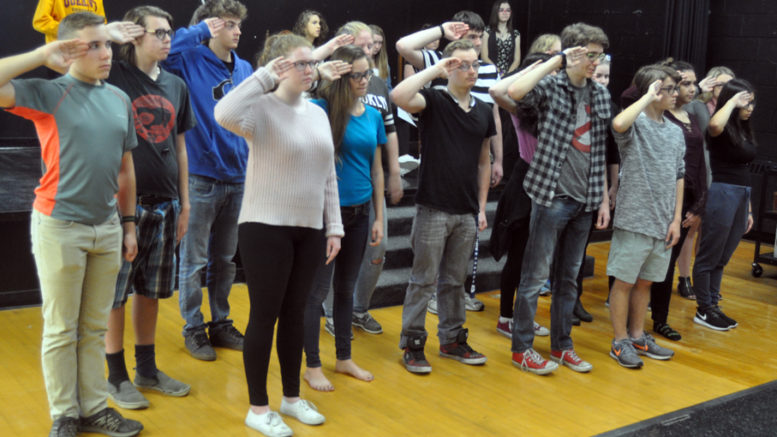 <p>A salute to local history – PECI drama students practice their salute during a scene in Vimy and the child soldier from Hillier where the township’s fallen veterans are remembered. The student are working on staging the play for community and in-school performances for Remembrance Day. (Adam Bramburger/Gazette staff)</p>
