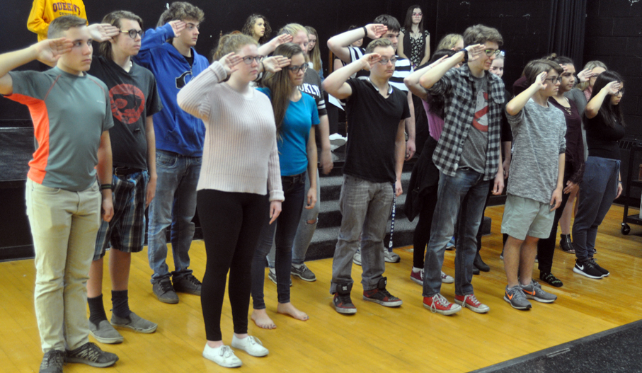<p>A salute to local history – PECI drama students practice their salute during a scene in Vimy and the child soldier from Hillier where the township’s fallen veterans are remembered. The student are working on staging the play for community and in-school performances for Remembrance Day. (Adam Bramburger/Gazette staff)</p>
