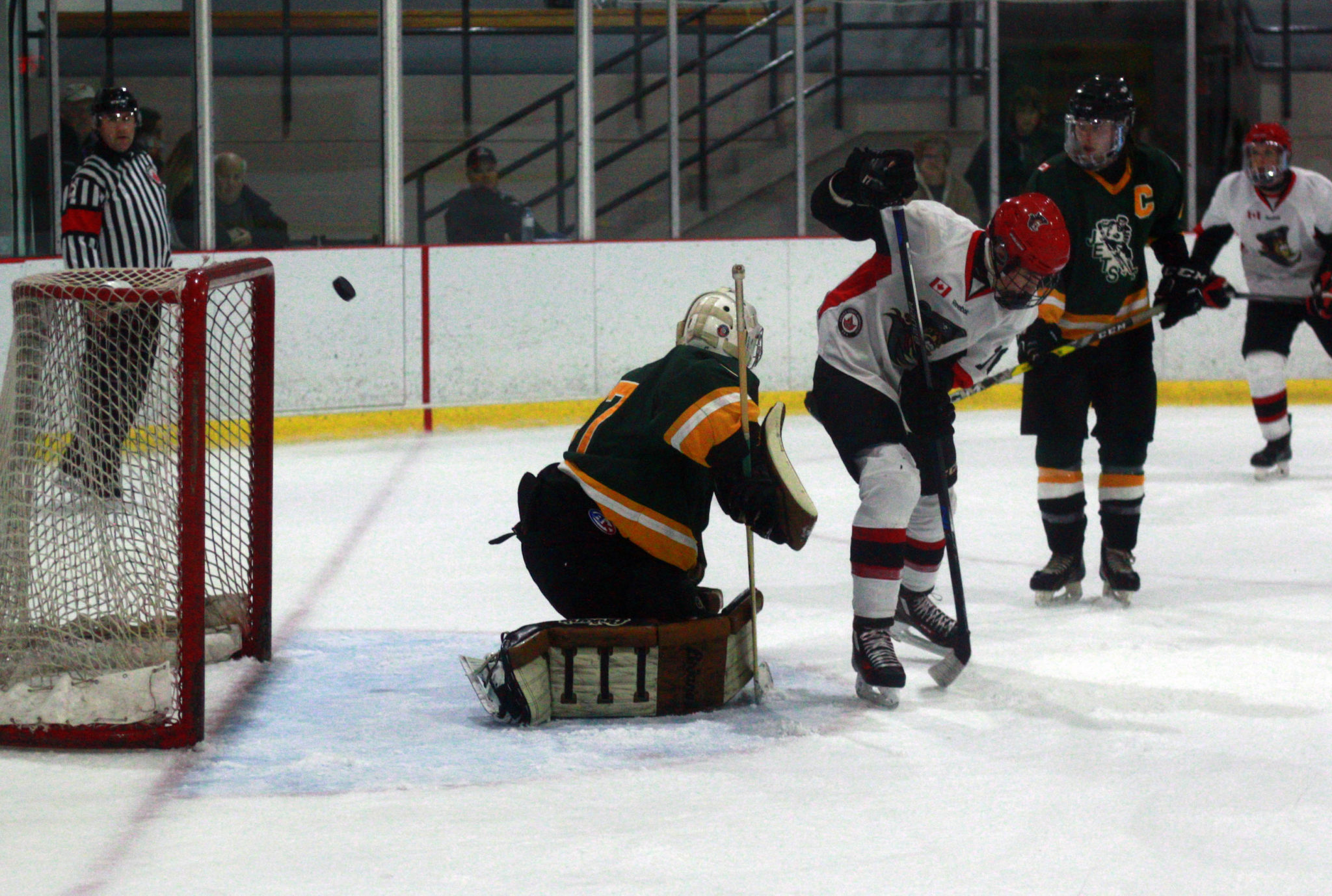 <p>Pirates forward Justin Arnold tips a shot up over Amherstview goalie Keegan Paulette.</p>
