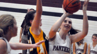 <p>Staying focused – Abby Margetson braces for contract from a Centennial Chargers defender as she attempts a shot under the basket Thursday A t left is teammate Lydia Snider. (Adam Bramburger/Gazette staff)</p>
