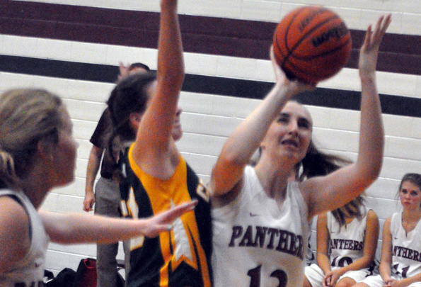 <p>Staying focused – Abby Margetson braces for contract from a Centennial Chargers defender as she attempts a shot under the basket Thursday A t left is teammate Lydia Snider. (Adam Bramburger/Gazette staff)</p>

