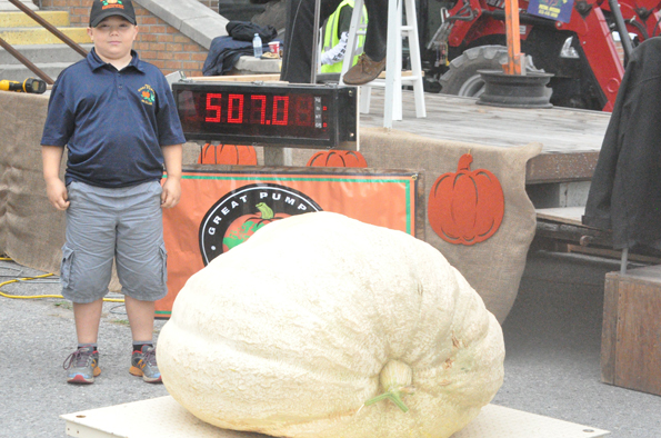 <p>A giant man – Carter Black, 11, of Huff’s Island Road is seen here with his large pumpkin entry. Black also brought a 152-lb watermelon to the weigh-off, the largest weighed in Canada this year. (Adam Bramburger/Gazette staff)</p>
