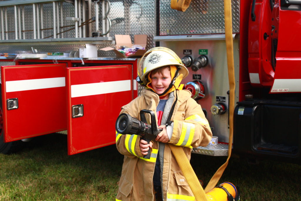 <p>Nine-year-old Rex Nelson tries on some firefighting equipment at Consecon Community Day.</p>

