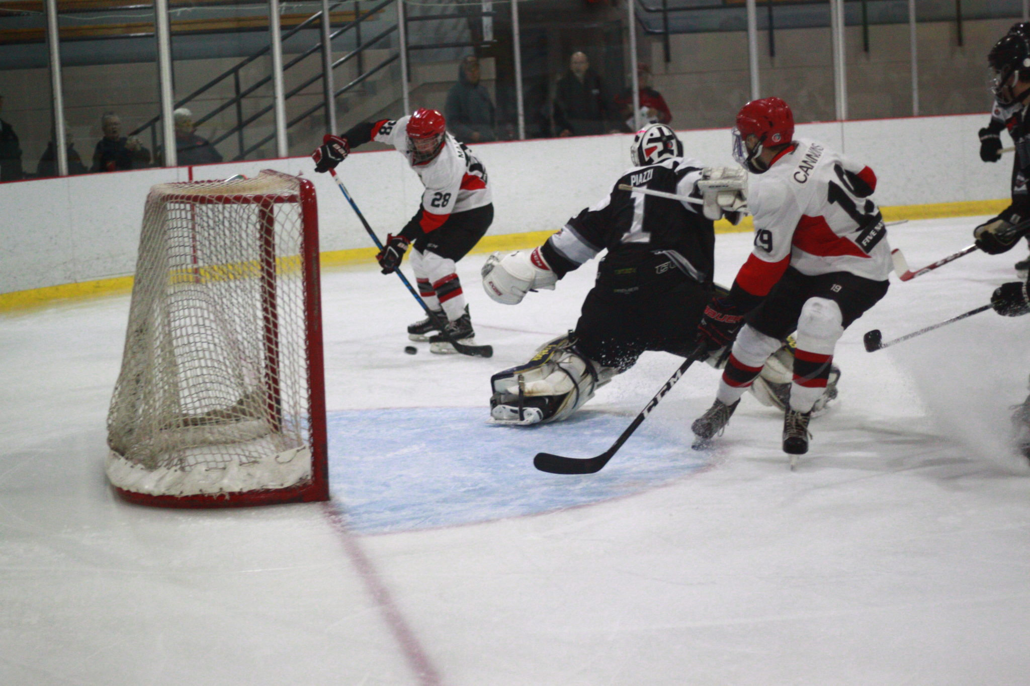 <p>Picton Pirates forwards Bailey Matthews and Jordon Cannons look to connect on an opportunity on Napanee goaltender Jeremy Piazzi.</p>
