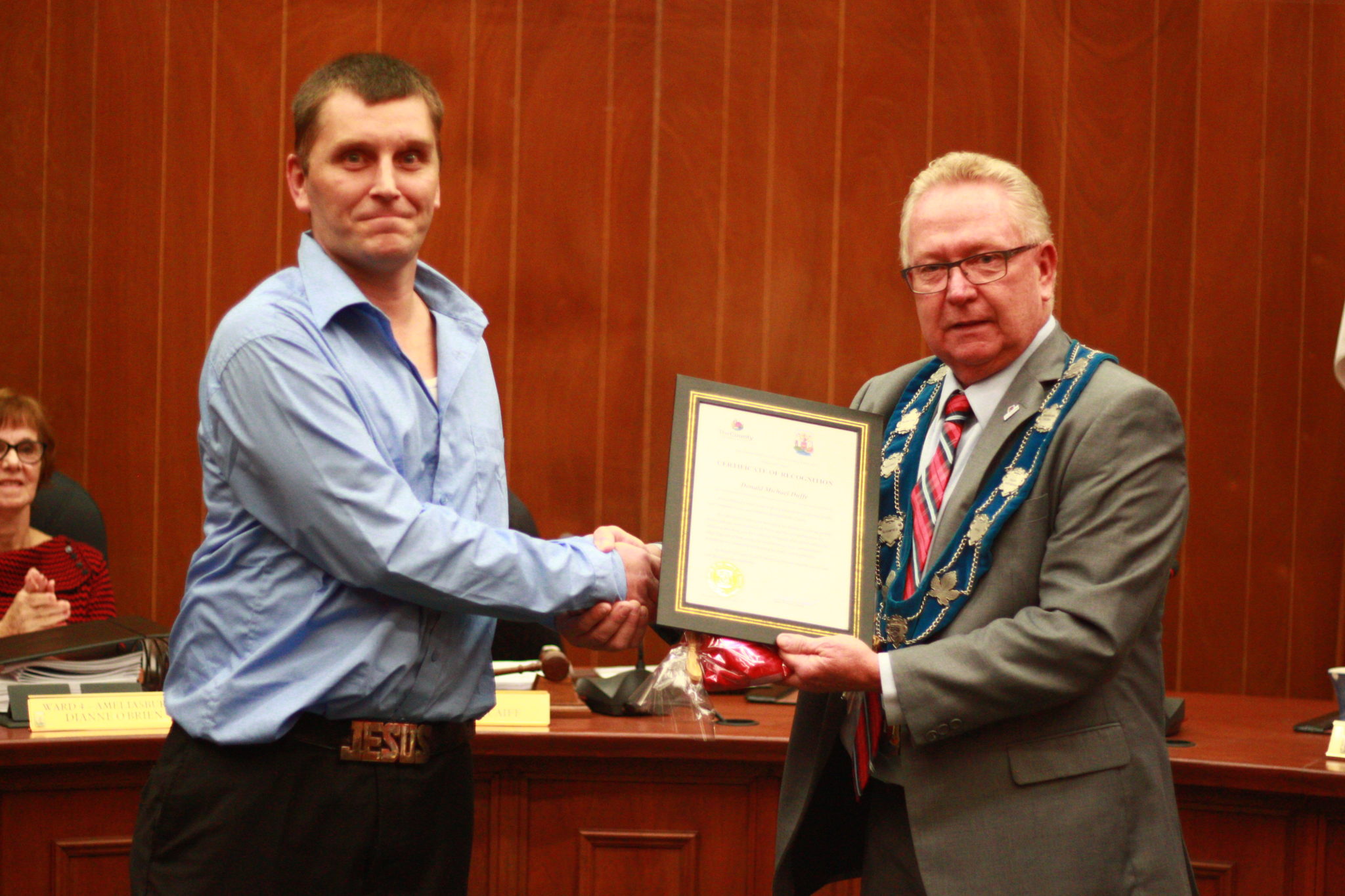 <p>Donnie Duffy receives a certificate from Mayor Robert Quaiff recognizing his efforts to clean up garbage and used needles around Picton. (Chad Ibbotson/Gazette staff)</p>
