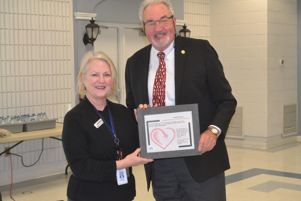 <p>TO HEALTH AND WELLNESS- Prince Edward County Memorial Hospital staff member Lawrie Ackerman was recognized by Quinte Health Care Tuesday for her commitment to workplace wellness. Presenting Ackerman with her recognition award is QHC Vice-Chair Stuart Wright. (Jason Parks/Gazette Staff)</p>
