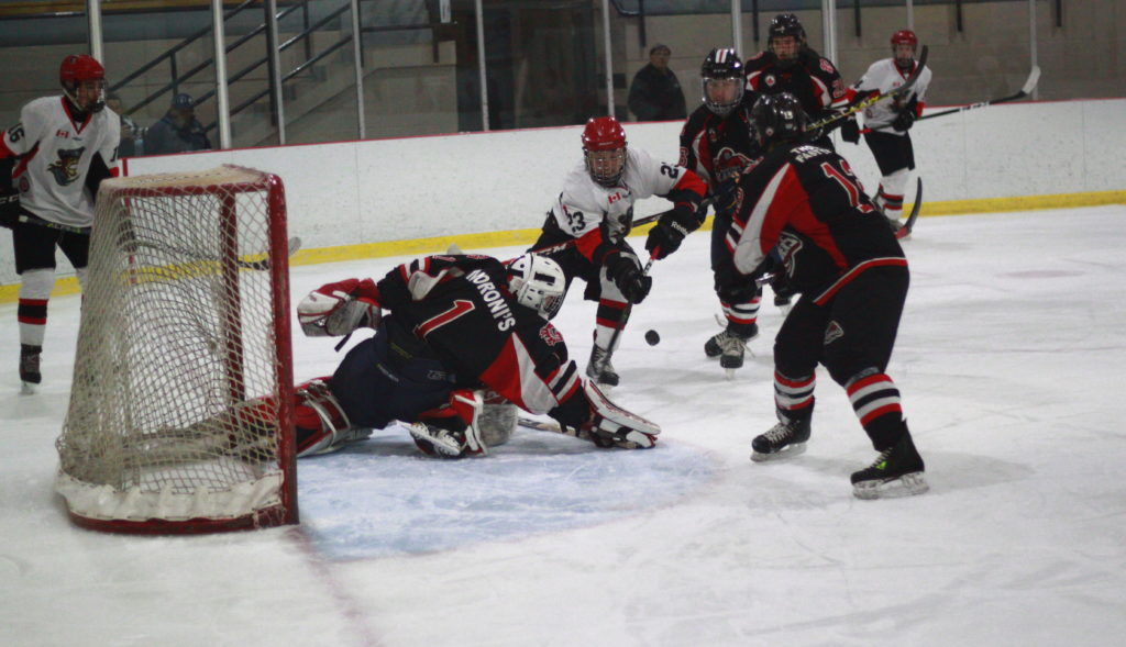 <p>Pirates forward Gerald Bilker drives to the net with Islanders goaltender Josh Rowden stretching to make the save. (Chad Ibbotson/Gazette staff)</p>
