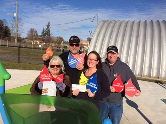 <p>Picton splash pad committee co-chairs Susan Quaiff and Phil St. Jean accept a cheque for $250 from Karie and Mike Campbell of Argyll Engraving. The company donated a portion of their time and cost for creating the donor raindrops that decorate the splash pad. Those seeking to support the splash pad can still purchase raindrops, walkway stones, equipment and other elements. Those interested are asked to contact Susan Quaiff at susanquaiff@gmail.com or on the Picton splash pad Facebook page. (Submitted photo) </p>

