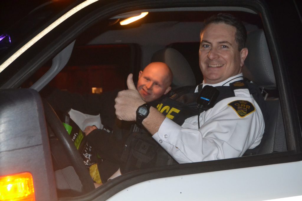 <p>Prince Edward OPP Staff Sergeant John Hatch and Detachment maintenance worker Luke Flynn at the Bloomfield Santa Claus parade. (Jason Parks/Gazette Staff.)</p>
