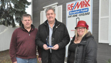 <p>Giving back – Re/Max Quinte associates (from left) Kevin Gale and Herb Pliwischkies show off their National Philanthropy Day Award for corporate giving alongside their nominator Briar Boyce of the Prince Edward County Memorial Hospital Foundation.  Re/Max has long supported the hospital and it recently stepped up its effort with the Teeing Off Fore Health Care Golf Classic. (Adam Brambugrer/Gazette staff)</p>
