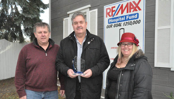 <p>Giving back &#8211; Re/Max Quinte associates (from left) Kevin Gale and Herb Pliwischkies show off their National Philanthropy Day Award for corporate giving alongside their nominator Briar Boyce of the Prince Edward County Memorial Hospital Foundation.  Re/Max has long supported the hospital and it recently stepped up its effort with the Teeing Off Fore Health Care Golf Classic. (Adam Brambugrer/Gazette staff)</p>
