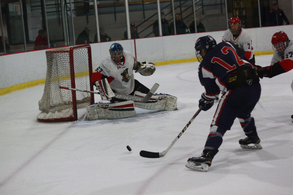 <p>Picton Pirates goaltender Aaron Young stares down Port Hope Panther Brad Bollert during the second period of last Thursday’s 6–2 loss. (Chad Ibbotson/Gazette staff)</p>
