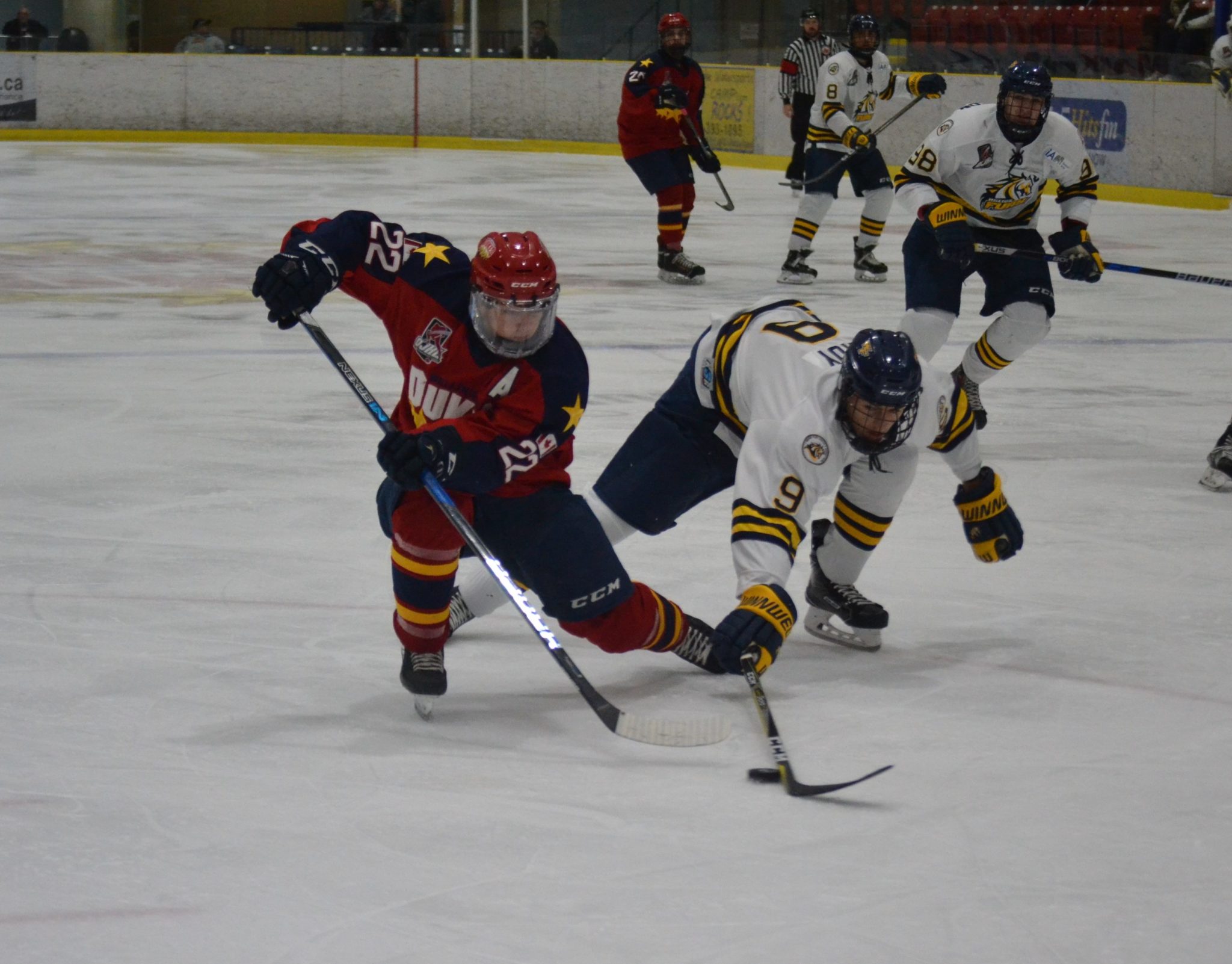 <p>Wellingto forward Mitch Martan tries to evade the checking of Whitby defender Joe Roy during the second period of a 0-0 tie at the Essroc Arena Friday evening. (Jason Parks/Picton Gazette)</p>
