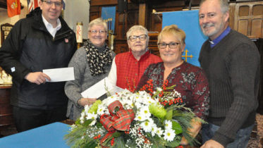 <p>Community giving – From left, Picton Salvation Army Lieut. Joseph Ludlow, Christmas Angel Tree co-ordinator Susan Rose, and Picton United Church County Food Bank representative Phyllis Mabee receive cheques from Picton United’s Community Christmas Carol Service organizer Pat Bentley and Rev. Rick Hamilton. (Adam Bramburger/Gazette staff)</p>
