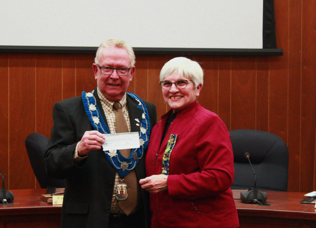 <p>Mayor Robert Quaiff accepts a cheque for $5,000 from Prince Edward District Women’s Institute president Evelyn Peck during Tuesday’s council meeting. The money will once again support specialized transit in Prince Edward County. (Chad Ibbotson/Gazette staff)</p>
