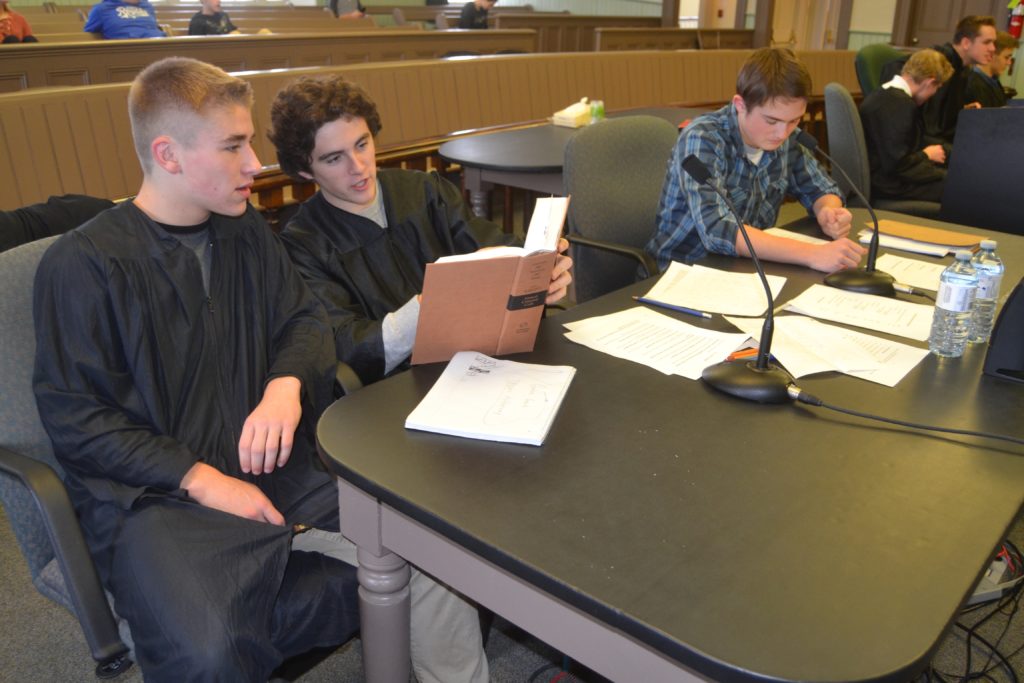 <p>BREAKING THE CODE- (From Left) Crown Attorneys Gabe Goad and Jack MacCool review a section of the criminal code of Canada while witness Dylan Morrow considers his upcoming testimony during a break at the Superior Courthouse in Picton. PECI students were practicing for the Hastings Cup Challenge to be held in Belleville next spring. (Jason Parks/Picton Gazette)</p>
