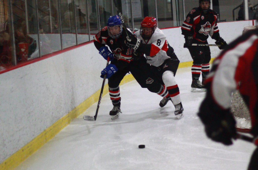 <p>Gananoque’s Jacob Ovens and Picton’s Noah Brant race for a loose puck during a Nov. 23 contest. (Chad Ibbotson/Gazette staff)</p>
