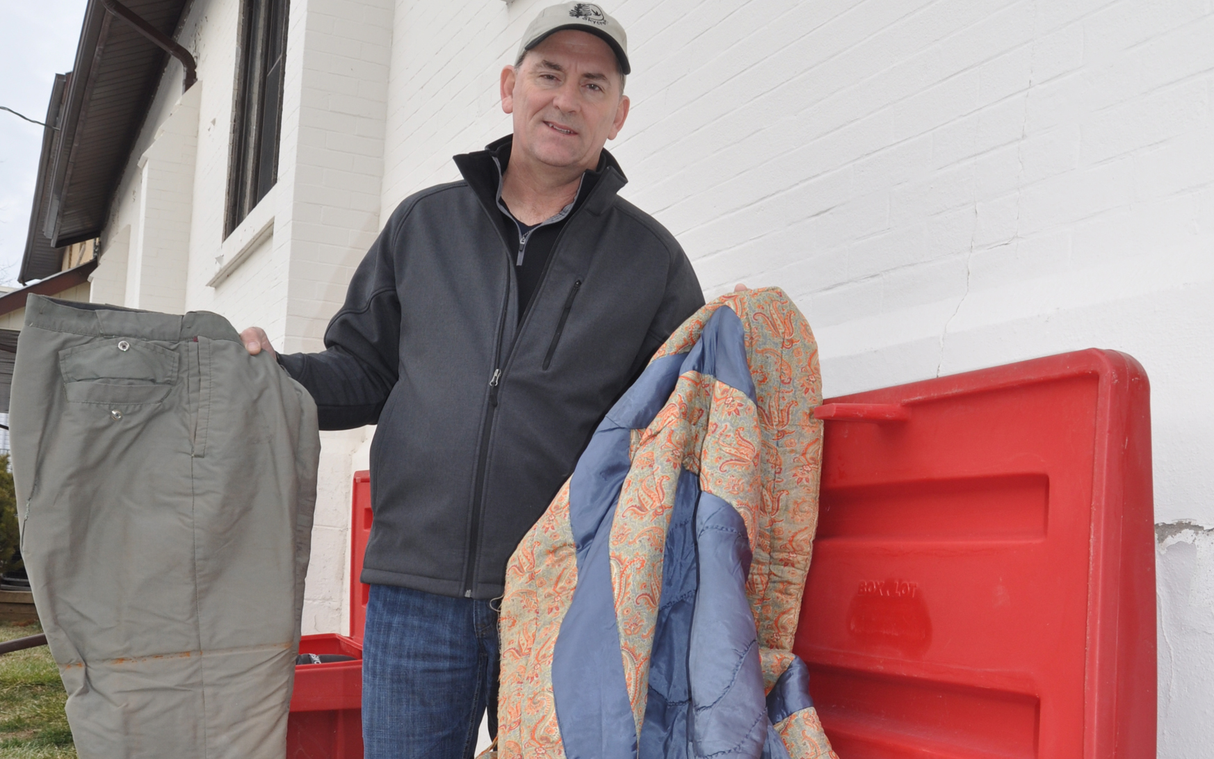 <p>Offering warmth &#8211; HOPE Centre pastor David Inch shows off a pair of snow pants and a blanket people in need of warmth can take from a box outside the church. (Adam Bramburger/Gazette staff)</p>
