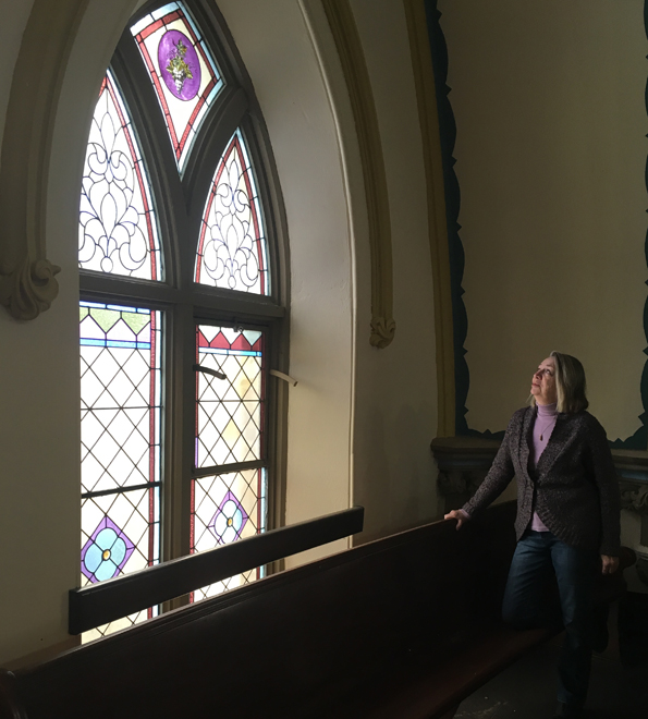 <p>Preserving panes -Picton United Church property and building committee chair Dianne Hadley studies one of the Victorian windows slated to be restored in the near future. (Adam Bramburger/Gazette staff)</p>
