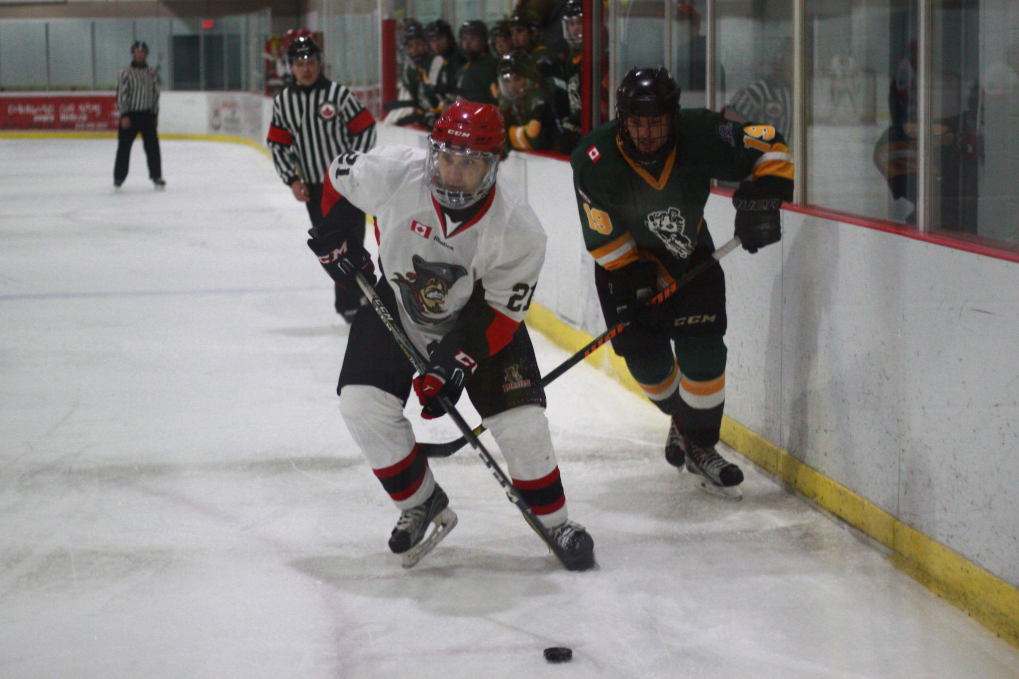 <p>Pirates forward Jayden Wood carries the puck into the Amherstview Jets zone with Cody Smith in pursuit during a Nov. 30 contest. (Chad Ibbotson/Gazette file photo)</p>
