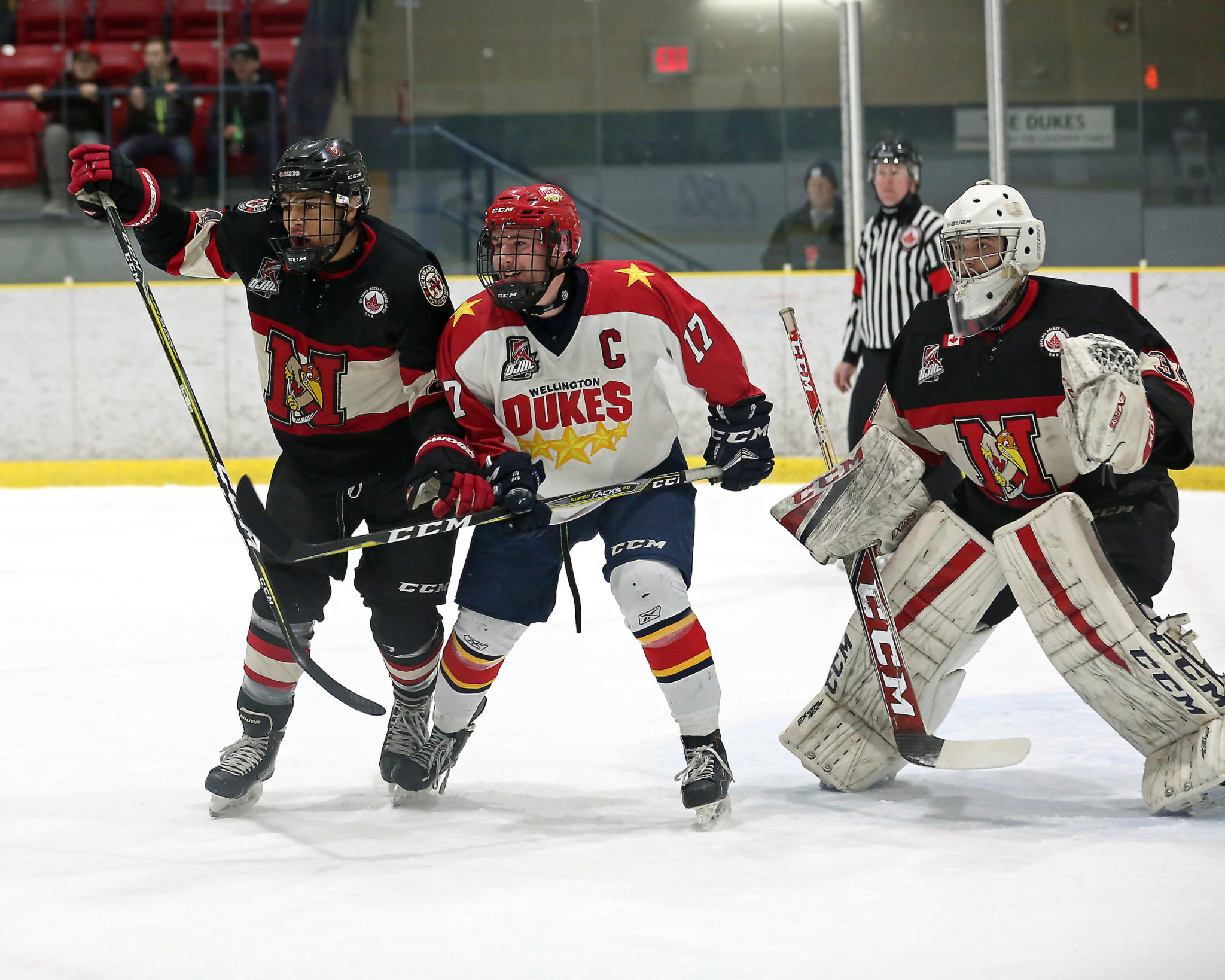 <p>IN THE EYE OF A HURRICANE – Wellington captain Colin Doyle battles for position between defenceman Adam Trotman and goaltender Fraser Kirk of the Newmarket Hurricanes during the first period of the Dukes’ 4-3 loss Wednesday night.<br />
(Photo by Ed McPherson / OJHL Images)</p>
