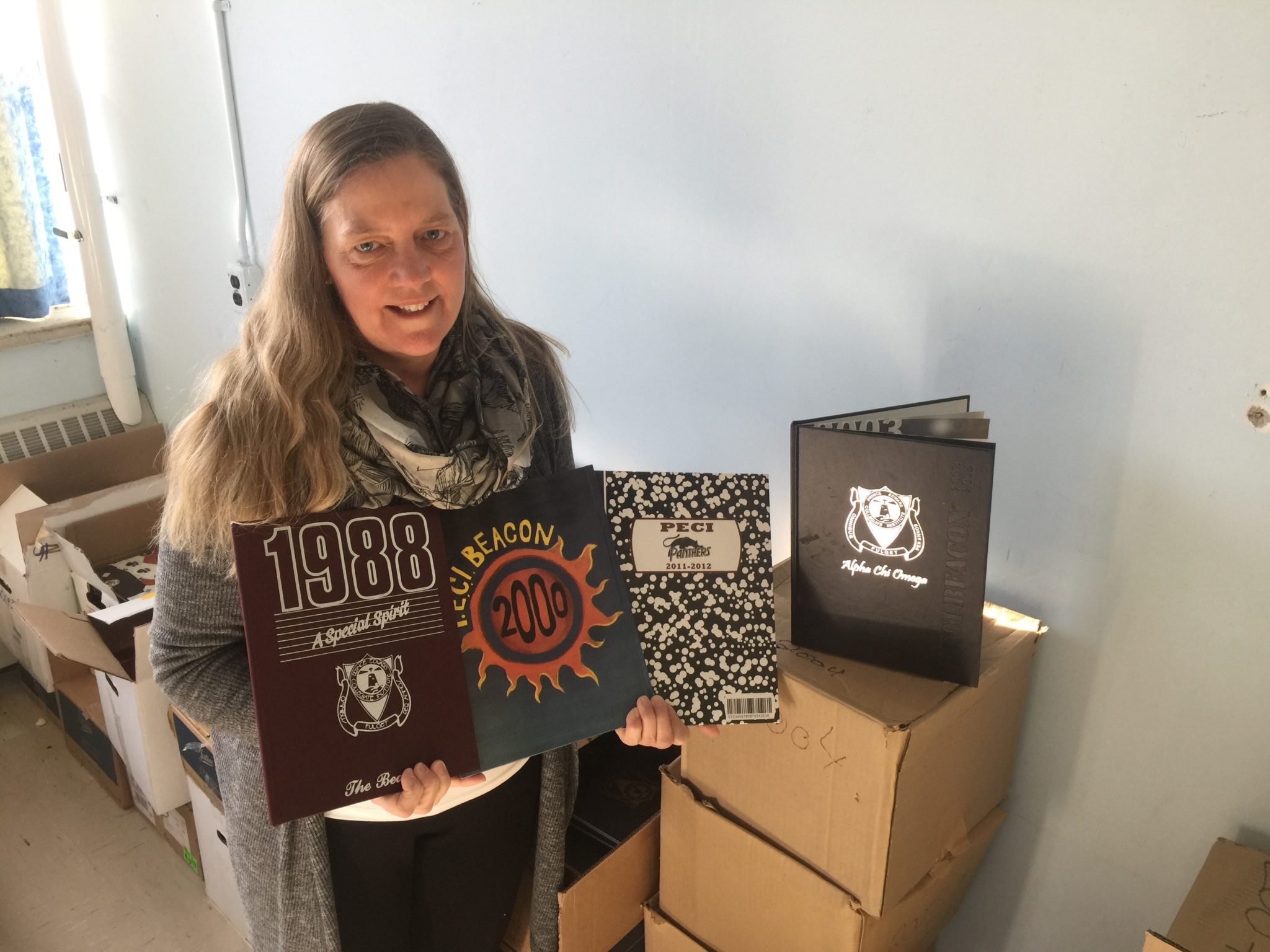 <p>IT SHINES THROUGHOUT THE YEARS- PECI teacher Hilary Anne Clarke is hoping to sell older editions of the PECI Yearbook &#8216;The Beacon&#8217; to alumni that may have lost or misplaced their copy. (Jason Parks/Gazette Staff)</p>
