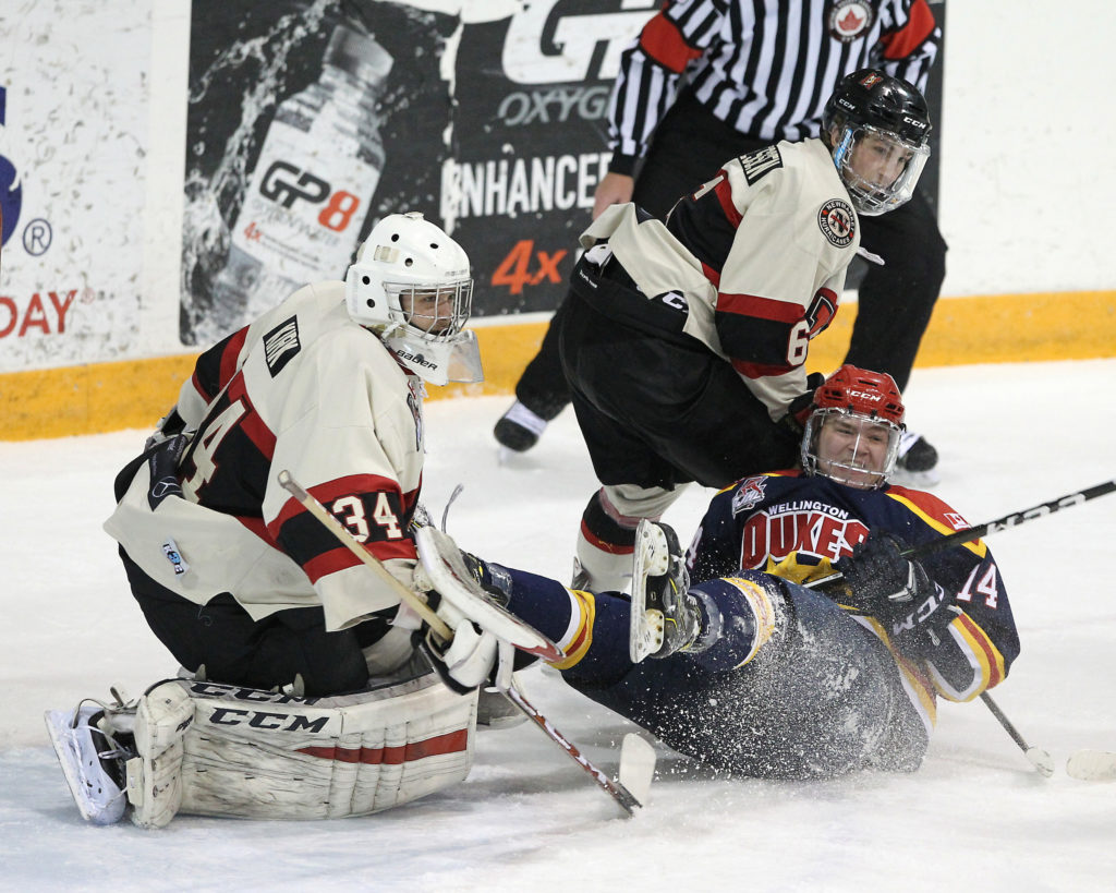 <p>TAKE A SEAT- Wellington Duke Ben Evans drives to the Newmarket net during the first period of Game 3 of the OJHL Northeast Conference Semi Finals as Hurricanes (From left) Fraser Kirk and Cole Thiessen attempt to stop his progress. Newmarket won the contest 8-1and have a 2-0 lead in the series.<br />
(Photo by Tim Bates / OJHL Images)</p>
