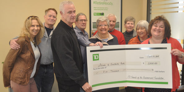 <p>Dunes deposit – TD Canada Trust Picton bank manager Shelly McDonald, right, presents a $5,000 grant to Friends of Sandbanks Provincial Park members (from left) Pamela Fraser, John Brebner, John Drechsler, Brian McLaughlin, Penny Spikes, Don Metcalf, Elaine Metcalf, and Agneta Sand for work on the Dunes Trail. (Adam Bramburger/Gazette staff)</p>
