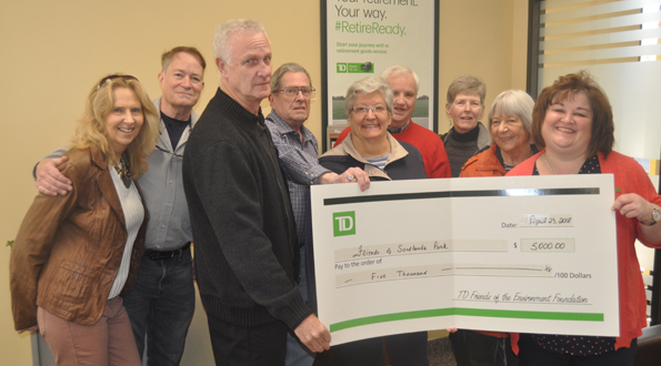 <p>Dunes deposit – TD Canada Trust Picton bank manager Shelly McDonald, right, presents a $5,000 grant to Friends of Sandbanks Provincial Park members (from left) Pamela Fraser, John Brebner, John Drechsler, Brian McLaughlin, Penny Spikes, Don Metcalf, Elaine Metcalf, and Agneta Sand for work on the Dunes Trail. (Adam Bramburger/Gazette staff)</p>

