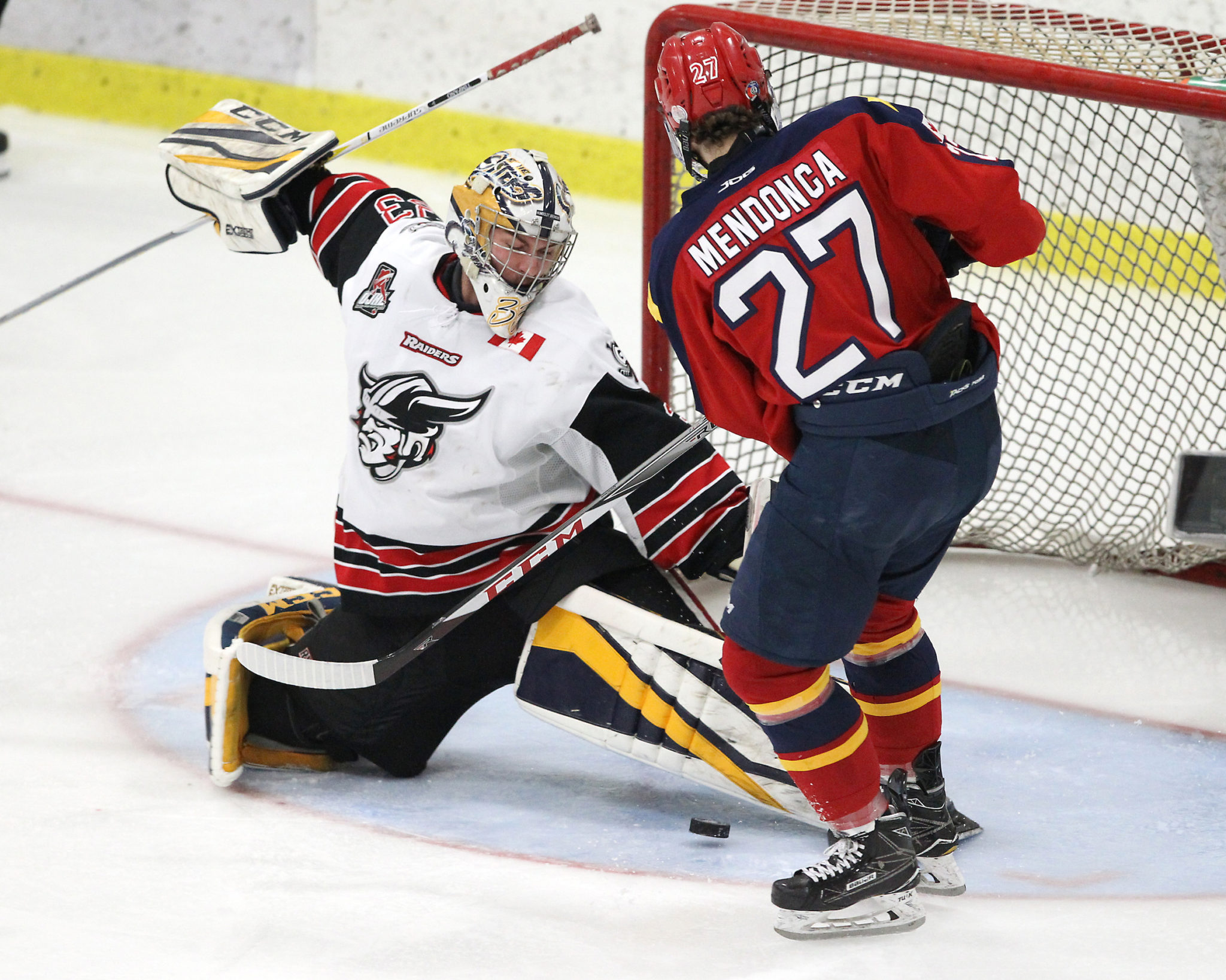 <p>WORKING OVERTIME- Wellington Duke Mitch Mendonca slips the puck under Georgetown Raiders goaltender Troy Timpano for the overtime winner in Game 1 of the 2018 Buckland Cup Finals.<br />
(Tim Bates/OJHL Images for the Gazette)</p>
