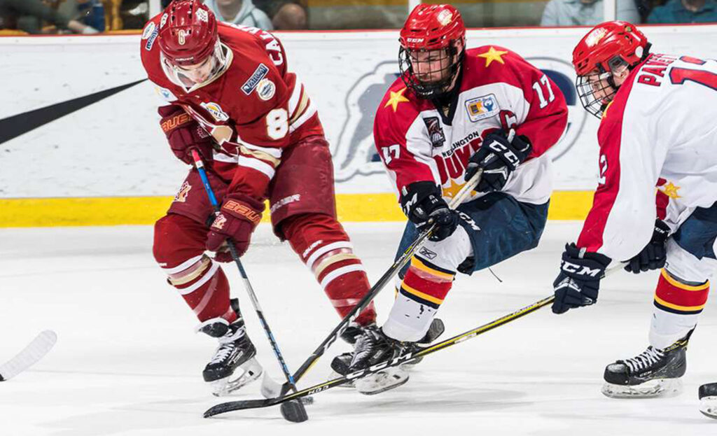 <p>Determined Dukes – Wellington’s Colin Doyle and Daniel Panetta battle Chilliwack’s Will Calverley in the RBC Cup final. The Chiefs scored three unanswered third period goals to win the national championship game 4-2. (Dave Holland/Hockey Canada Images)</p>
