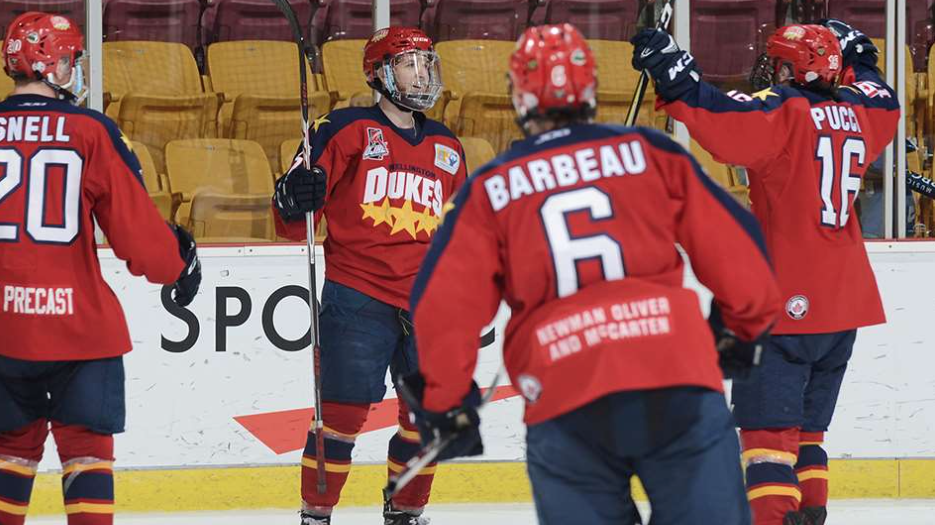 <p>FINDING A WAY- Wellington Dukes teammates surround Mitchell Mendonca after the forward scored a game-tying goal in the third period of the club&#8217;s 3-2 win over the Steinbach Pistons Monday at the 2018 Royal Bank Cup in Chilliwack, BC. (Matthew Murnaghan/Hockey Canada Images) </p>
