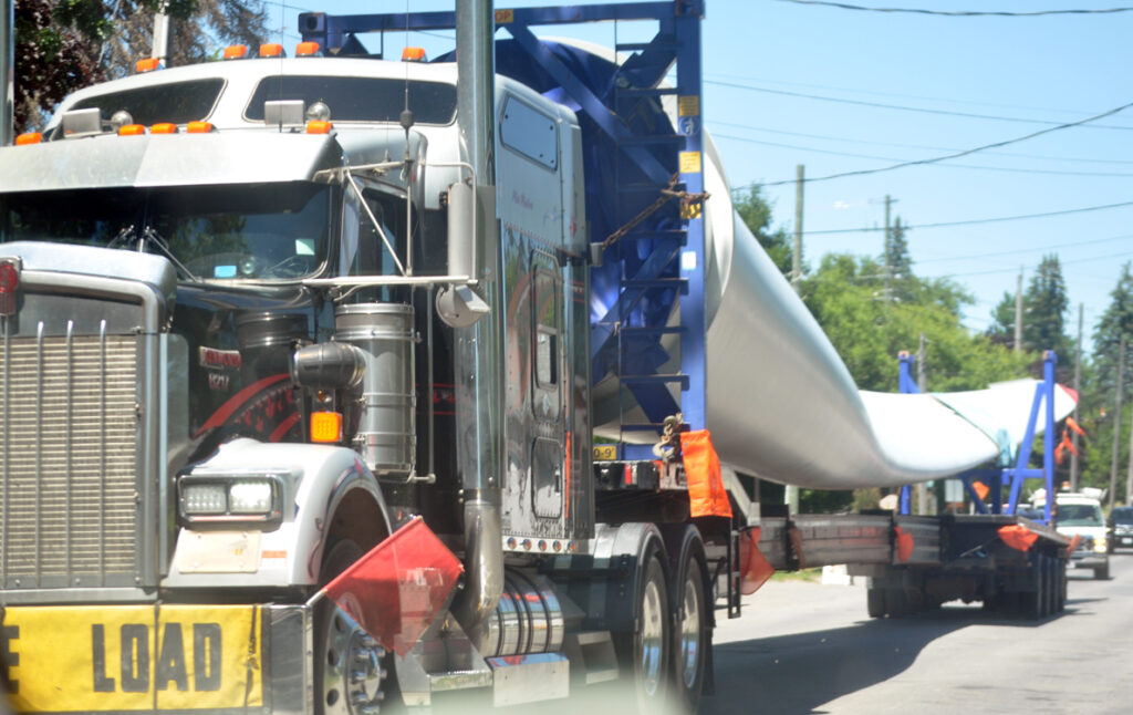 <p>Big blade – Components for the nine-turbine White Pines Wind Project carried on local roads toward construction sites in South Marysburgh in June.  (Adam Bramburger/Gazette staff)</p>
