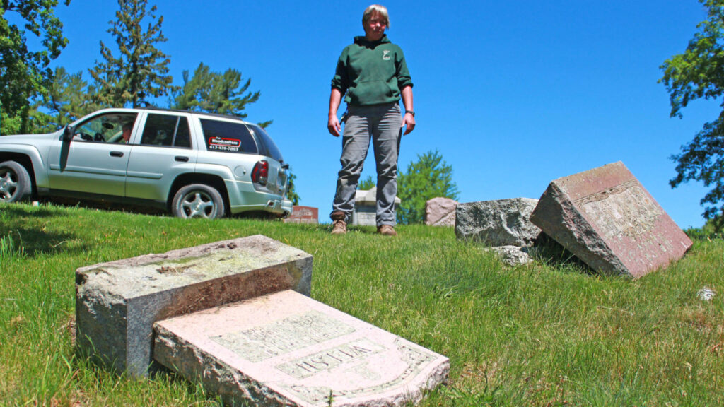 <p>Glenwood cemeterian and grounds manager Helma Oonk stands over a pair of toppled markers. (Chad Ibbotson/Gazette File Photo)</p>
