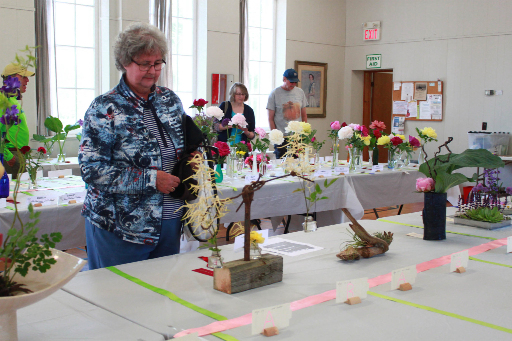 <p>Nancy Lockyer checks out some of the flowers on display during County Blooms. (Chad Ibbotson/Gazette staff)</p>
