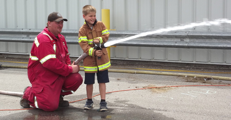 <p>The real thing – With some help from firefighter Mark Gilbert, 8-year-old Braden Nyman of Carrying Place     handled a real fire hose during Saturday’s challenge event in Wellington. (Terry McNamee/For The Gazette)</p>
