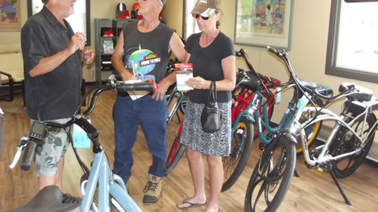 <p>New wheels – Patrick Maloney (left), co-owner of Pedego Electric Bikes in Bloomfield, chatted with John and Lorraine Bowers of Quinte West during the shop’s grand opening on Saturday, June 9. (Terry McNamee/For The Gazette)</p>
