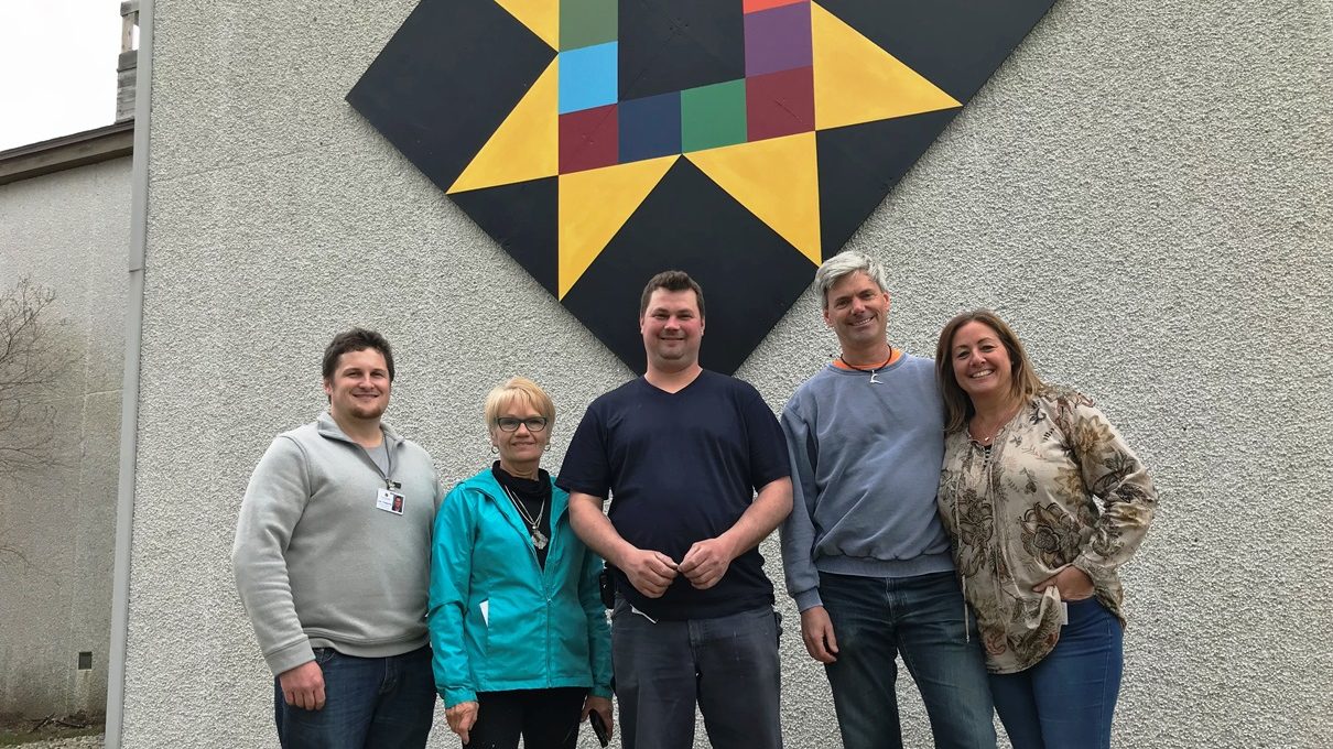 <p>From left, McFarland Home food service supervisor Joe Chapman, PEC Barn Quilt Trails co-ordinator Pat Dubyk, McFarland Home maintenance employee Brian Westervelt, volunteer Chris Cloudsdale, and administrator Kim Mauro unveil one of the new quilts. (Submitted photo)</p>
