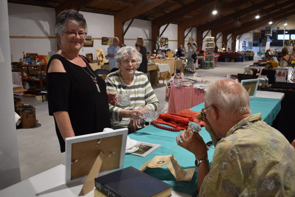 <p>CLOSE EXAMINATION- Don Roberts examines a century old cut glass crystal dish brought to him by (From left) Claudia Buchanan and Joanne Pierson at the 2018 Antique, Vintage and Retro show at the Prince Edward Curling Club Friday. (Jason Parks/Gazette Staff)</p>

