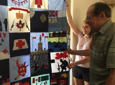 <p>HONOURING A HERO- Picton resident George Wright examines a quilt presented to him by PECI&#8217;s Grade 10 Venture class. The quilt was identified this weekend at the Stitch in Time Quilt show and will be part of the Quilts of Valour program. (Submitted Photo)</p>
