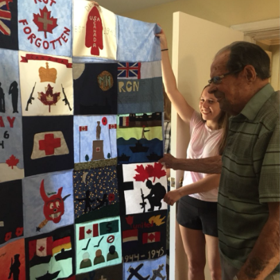 <p>HONOURING A HERO- Picton resident George Wright examines a quilt presented to him by PECI’s Grade 10 Venture class. The quilt was identified this weekend at the Stitch in Time Quilt show and will be part of the Quilts of Valour program. (Submitted Photo)</p>
