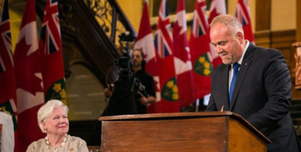 <p>sworn in Bay of Quinte MPP Todd Smith signs an affirmation after being named Minister of Government and Consumer Services as Lt.-Gov Elizabeth Dowdeswell looks on Friday. (Legislative Assembly of Ontario)</p>
