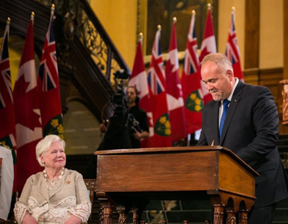 <p>sworn in Bay of Quinte MPP Todd Smith signs an affirmation after being named Minister of Government and Consumer Services as Lt.-Gov Elizabeth Dowdeswell looks on Friday. (Legislative Assembly of Ontario)</p>
