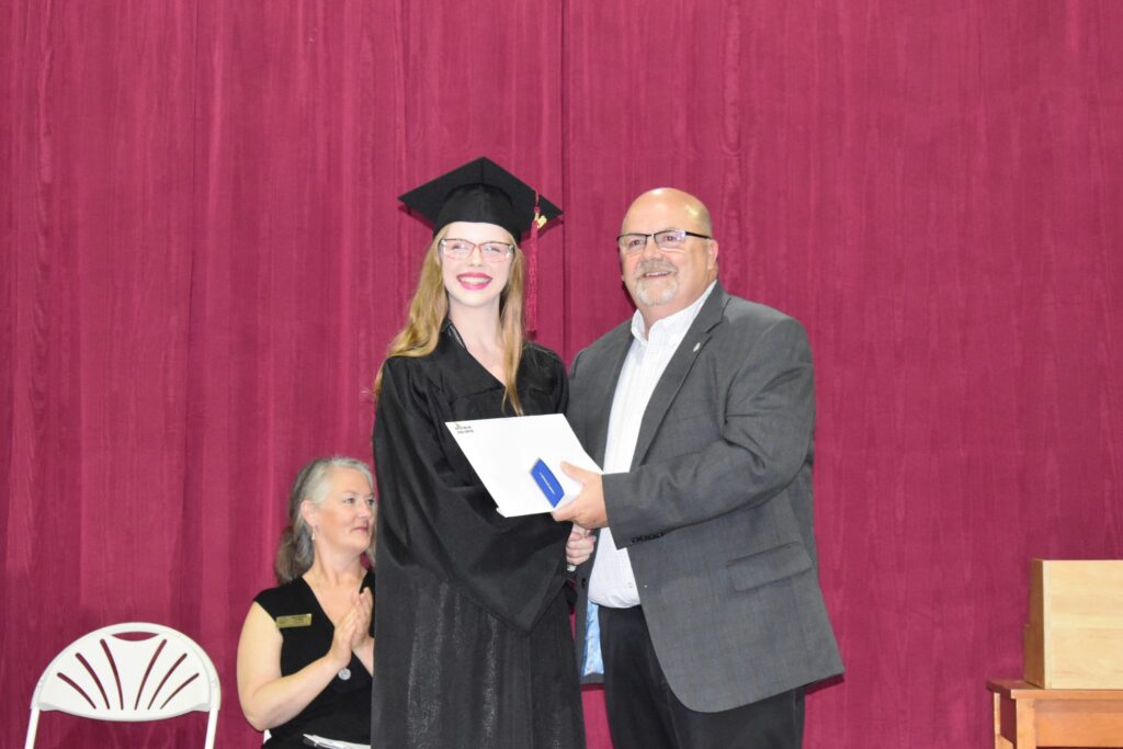 <p>Top student – PECI graduate Skylar Pierson accepts the 2018 Governor General’s Medal for highest academic standing from Prince Edward South school board trustee Dwayne Inch at the secondary school’s graduation ceremony at the Prince Edward Community Centre Thursday. (Jason Parks/Gazette Staff)</p>
