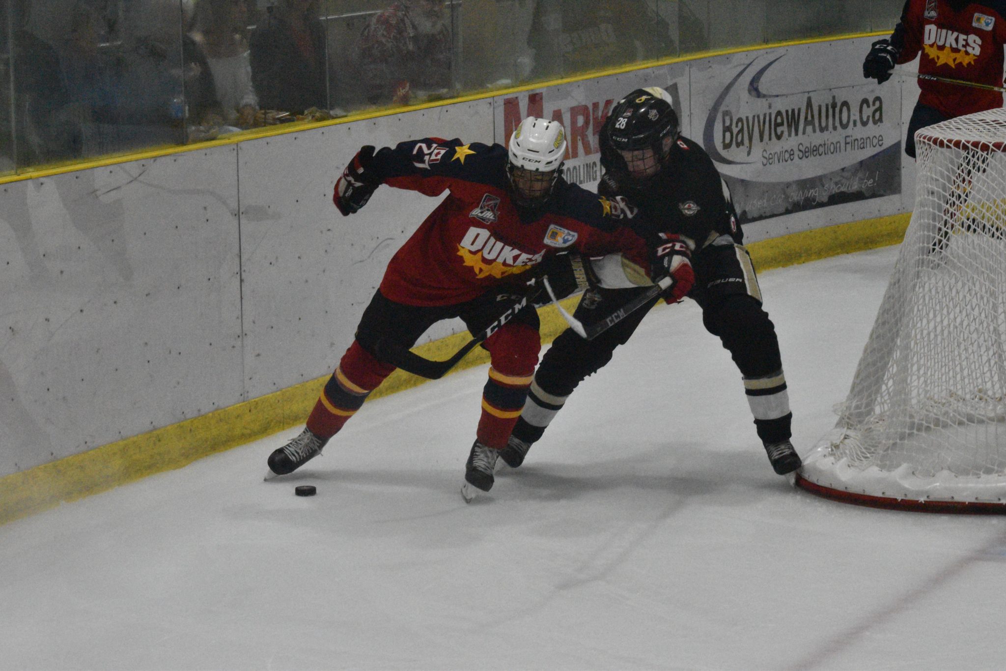 <p>ANY MEANS NECESSARY -Wellington Dukes forward Elijah Gonsalves tries to move the puck with his skate while being held up by Trenton Golden Hawk defender Chris Tamer. Gonsalves had the game-wining goal in a 4-2 Wellington win. (Jason Parks/Gazette Staff)</p>
